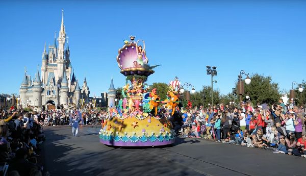 Example of Disney World Parade with castle in background. Put into blog post for potential benefits of using an ECV or wheelchair after COVID-19.