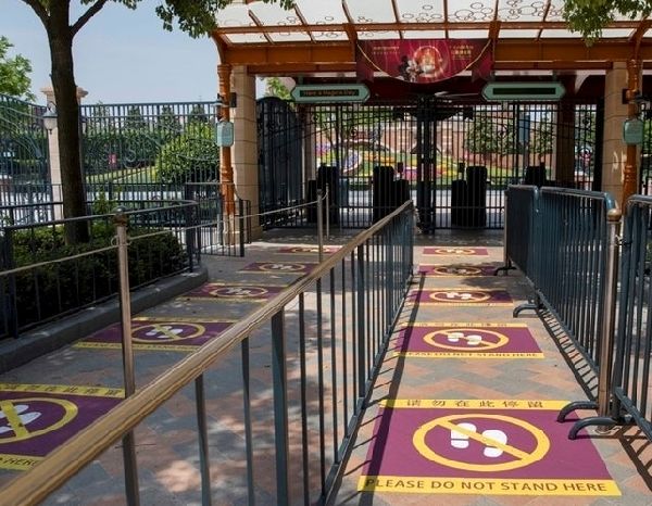 Ground Markers at Shanghai Disneyland in blog post for potential benefits of using an ECV or wheelchair after COVID-19.