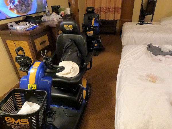 This image shows two mobility scooter in a room at the Caribbean Beach Resort.