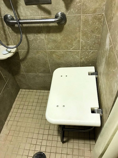 Inside Shower At Caribbean Beach Showing Shower Seat in down position
