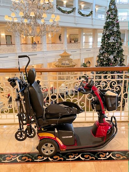 Image of my GMS rental scooter from the 2nd floor of the Grand Floridian with the Christmas tree in the background.
