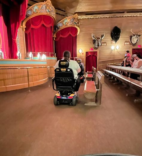 Images of mobility scooters entering into Grizzly Hall seating area.