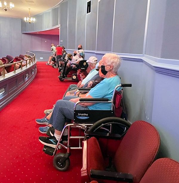 Image of guests lined up against the back row of Hall of Presidents theatre